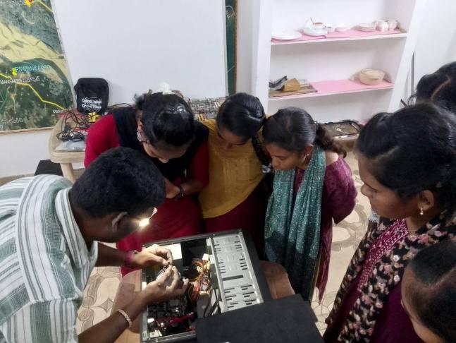 Participants learning practical computer repair skills
