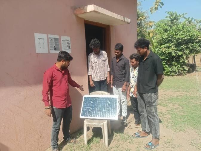 Trainees working with a solar panel during practical instruction